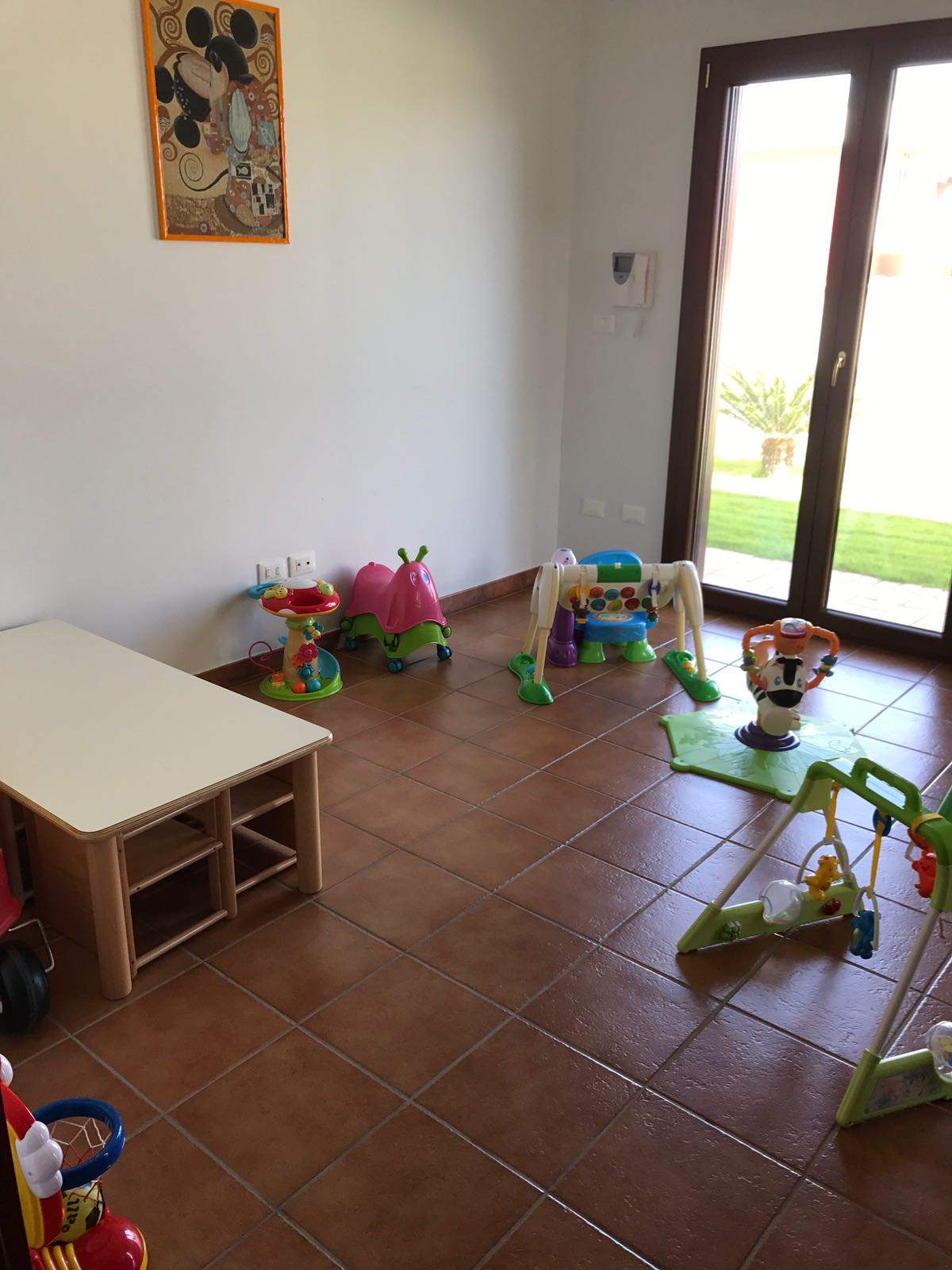 Sala luminosa con grande finestra sul giardino